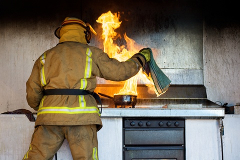 fireman putting out a stove fire